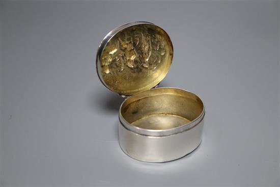 A George III oval silver box and cover, the lid embossed with imbibers, London, 1797, 74mm, 119 grams.